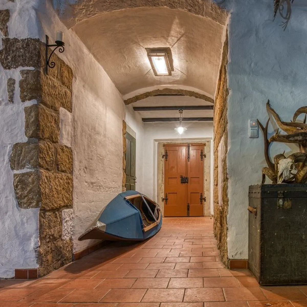 Gewölbekeller mit Kajak, Geweih und historischer Truhe